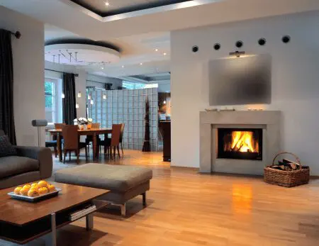 A living room with a fireplace and wooden floors